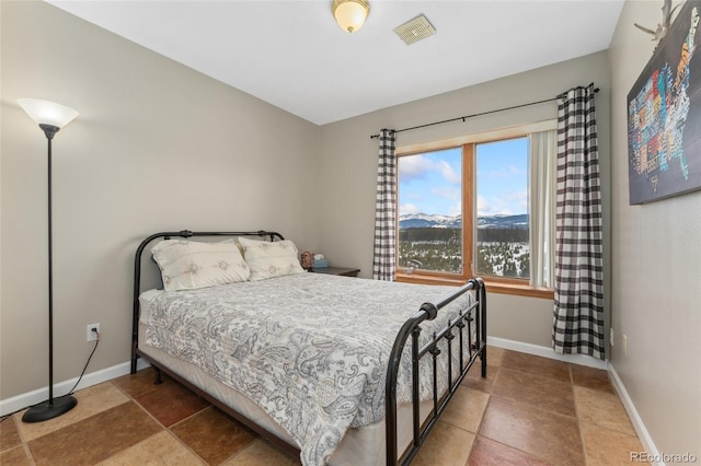 bedroom featuring a mountain view, baseboards, and visible vents