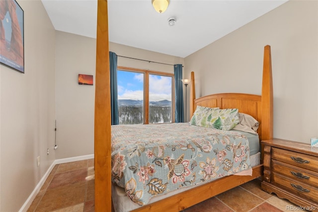 tiled bedroom featuring baseboards