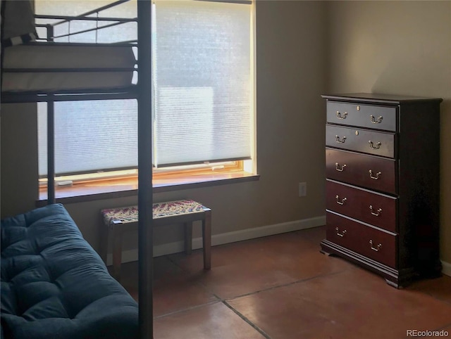 bedroom featuring baseboards, multiple windows, and tile patterned flooring