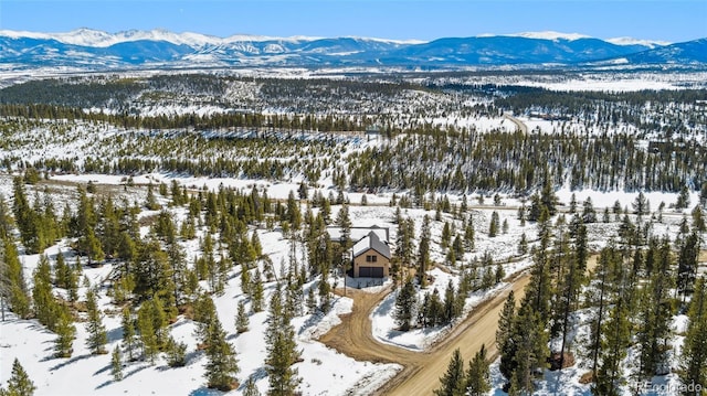 snowy aerial view featuring a mountain view