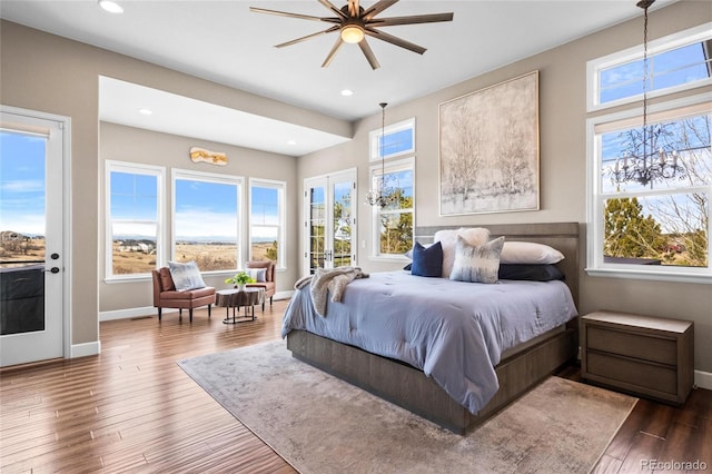 9563 Red Primrose St, Franktown, CO 80116 - bedroom with multiple windows, wood finished floors, baseboards, and recessed lighting