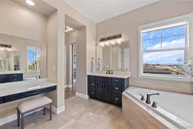 9563 Red Primrose St, Franktown, CO 80116 - full bath featuring a garden tub, vanity, baseboards, and tile patterned flooring