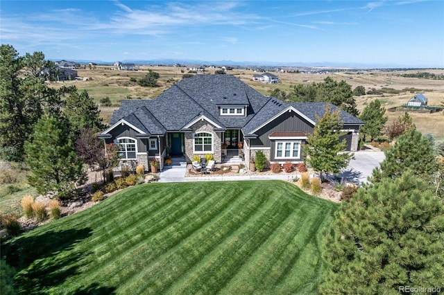 9563 Red Primrose St, Franktown, CO 80116 - craftsman-style home featuring stone siding, a front lawn, board and batten siding, and concrete driveway