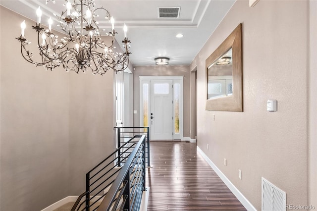 9563 Red Primrose St, Franktown, CO 80116 - hall with baseboards, dark wood-type flooring, a chandelier, a raised ceiling, and recessed lighting