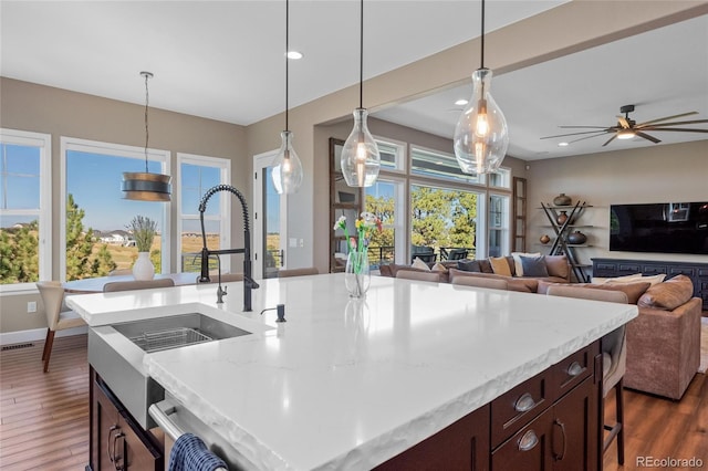 9563 Red Primrose St, Franktown, CO 80116 - kitchen with plenty of natural light, open floor plan, dark wood-style flooring, pendant lighting, and recessed lighting