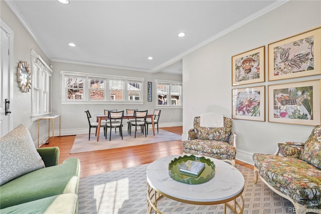 living room featuring ornamental molding and light wood-type flooring