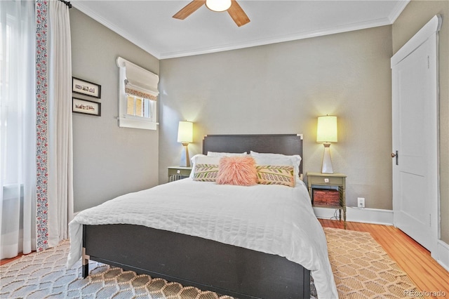 bedroom featuring ornamental molding, hardwood / wood-style floors, and ceiling fan