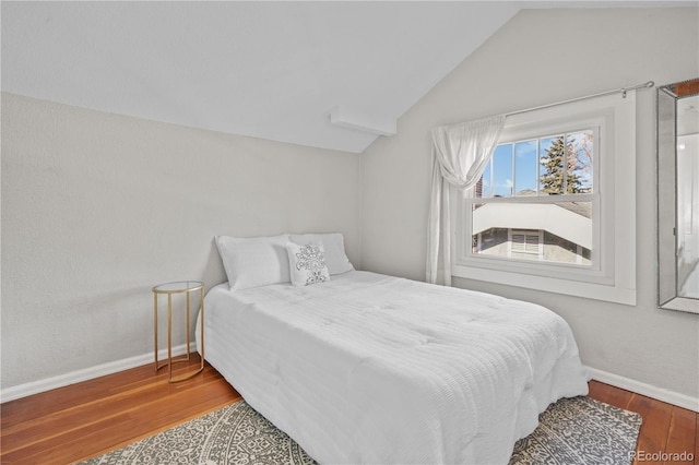 bedroom with hardwood / wood-style flooring and vaulted ceiling