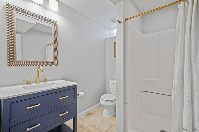 bathroom with vanity, tile patterned flooring, toilet, and walk in shower