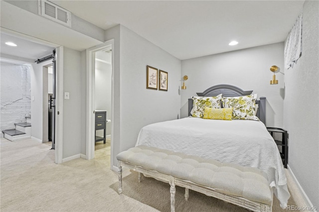 carpeted bedroom featuring a barn door