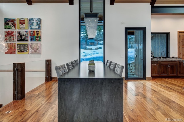 65 Aerie Dr, Silverthorne, CO 80498 - unfurnished dining area featuring light wood-style floors and beam ceiling