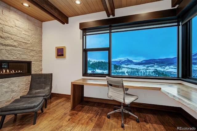 65 Aerie Dr, Silverthorne, CO 80498 - home office with built in study area, wood finished floors, a wood ceiling with exposed beams, a mountain view, and a fireplace