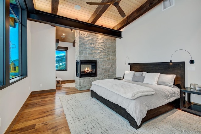 65 Aerie Dr, Silverthorne, CO 80498 - bedroom featuring wood finished floors, wooden ceiling, a fireplace, and ceiling fan