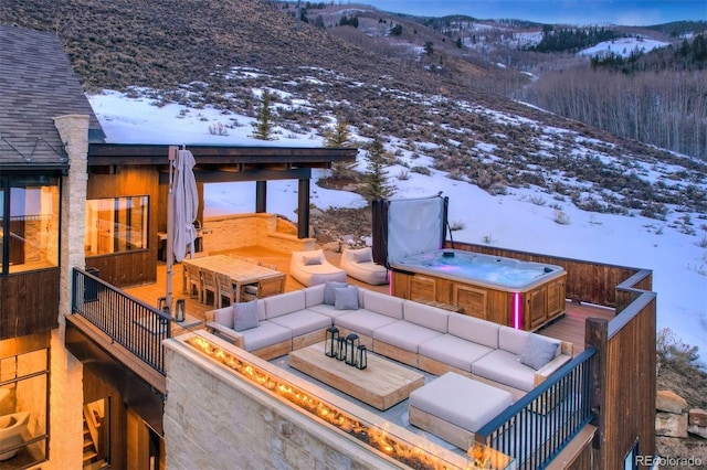 65 Aerie Dr, Silverthorne, CO 80498 - snow covered deck with a hot tub, an outdoor hangout area, and a mountain view
