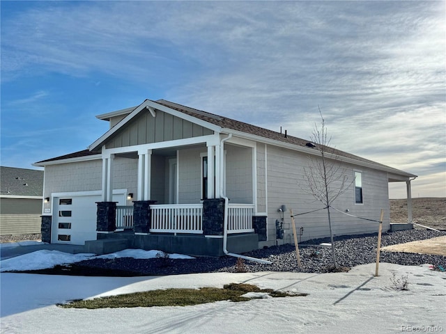 view of front of property with a porch and a garage