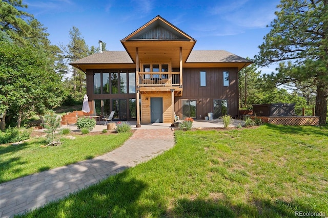 776 Hilltop Rd, Palmer Lake, CO 80133 - rear view of house featuring a patio, a shingled roof, a yard, and a balcony