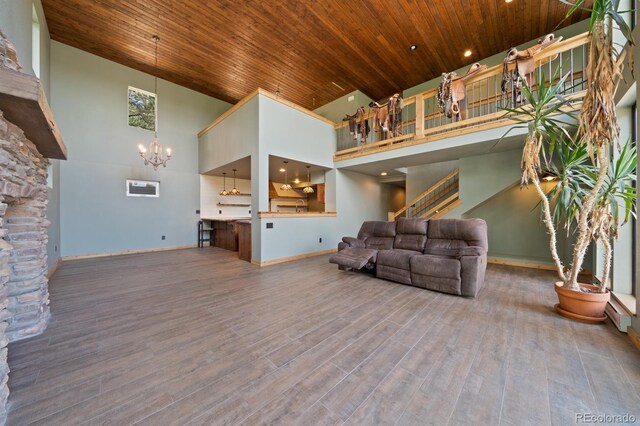776 Hilltop Rd, Palmer Lake, CO 80133 - living room featuring stairway, a high ceiling, wood ceiling, a notable chandelier, and wood finished floors