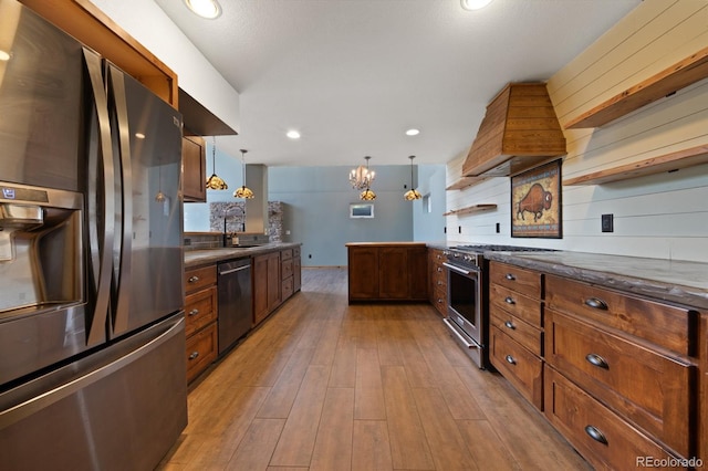776 Hilltop Rd, Palmer Lake, CO 80133 - kitchen with custom exhaust hood, a peninsula, stainless steel appliances, open shelves, and light wood-type flooring