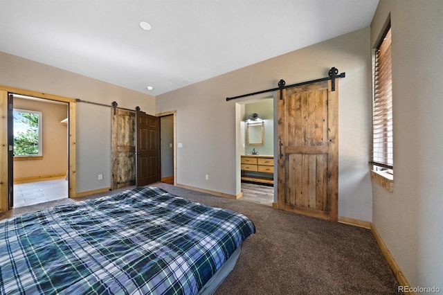 776 Hilltop Rd, Palmer Lake, CO 80133 - carpeted bedroom featuring baseboards, a barn door, and ensuite bathroom