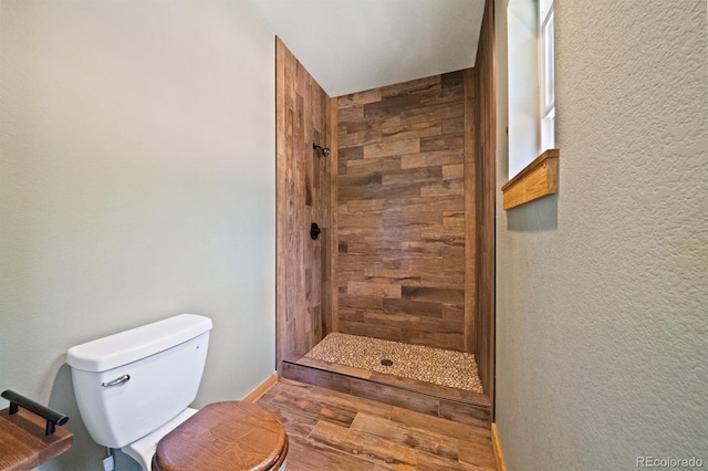 776 Hilltop Rd, Palmer Lake, CO 80133 - bathroom with toilet, a stall shower, and wood finished floors