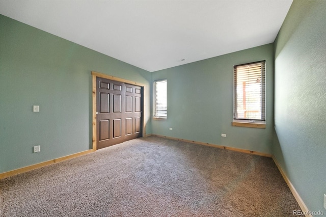 776 Hilltop Rd, Palmer Lake, CO 80133 - unfurnished bedroom with baseboards, a closet, and carpet floors