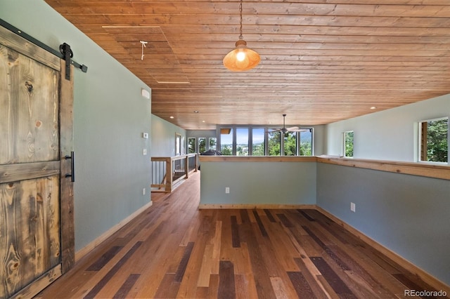 776 Hilltop Rd, Palmer Lake, CO 80133 - unfurnished room with hardwood / wood-style floors, plenty of natural light, wooden ceiling, and a barn door