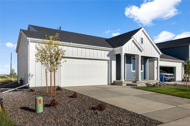 modern farmhouse style home with a garage, covered porch, board and batten siding, and a shingled roof