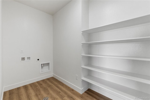 washroom with hookup for an electric dryer, wood finished floors, washer hookup, and baseboards