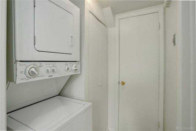 laundry room with stacked washer / dryer
