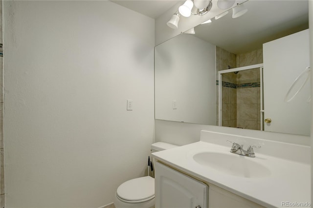 bathroom featuring vanity, toilet, and a shower stall