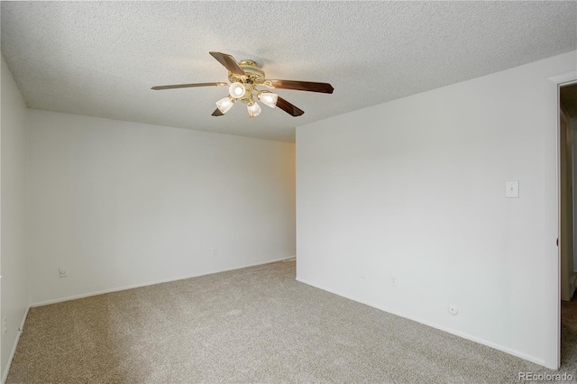 unfurnished room featuring a textured ceiling, carpet floors, and a ceiling fan