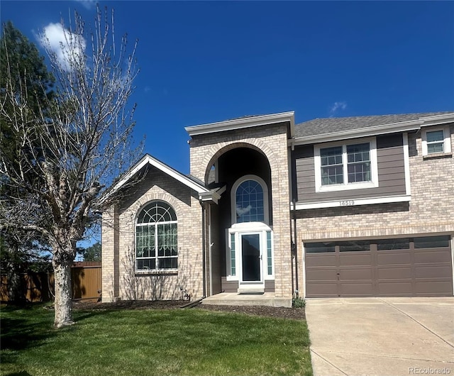 traditional-style house with concrete driveway, an attached garage, and brick siding