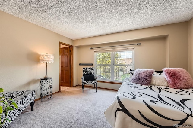 carpeted bedroom featuring baseboards and a textured ceiling