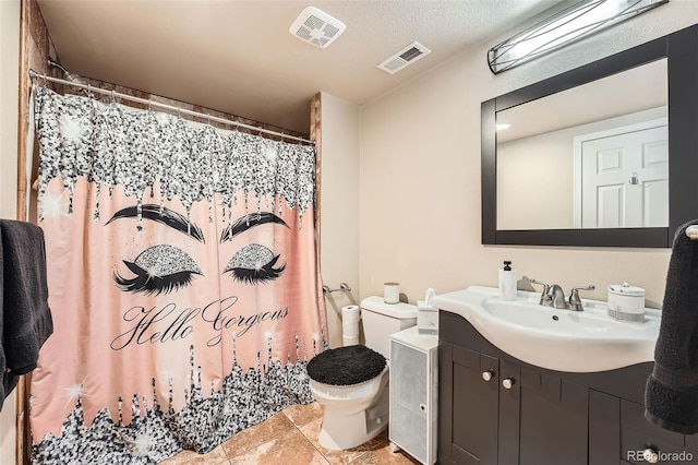 bathroom with vanity, toilet, a shower with shower curtain, and tile patterned floors