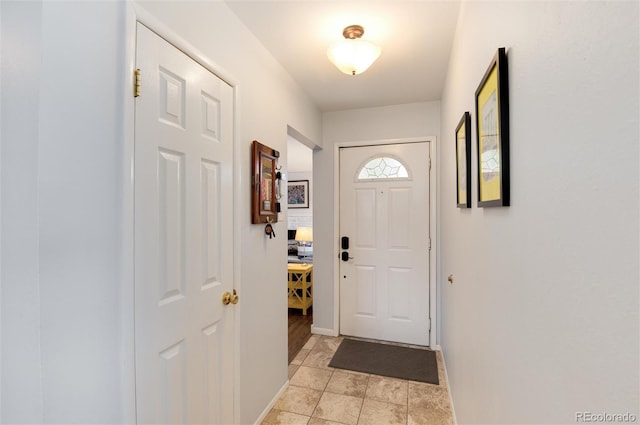 doorway to outside featuring baseboards