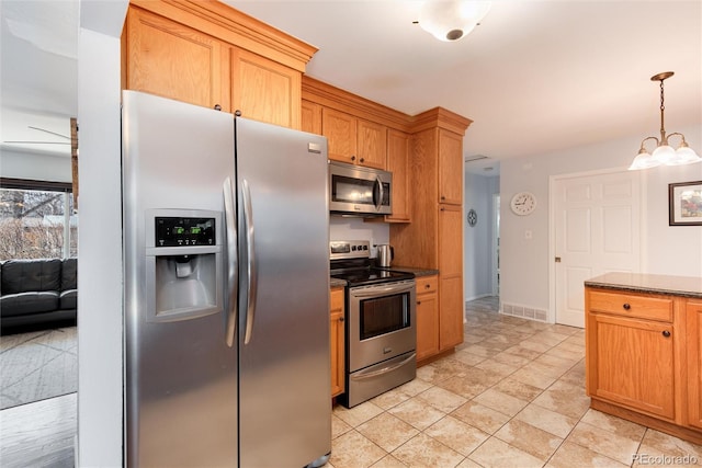 kitchen featuring dark countertops, visible vents, a chandelier, decorative light fixtures, and appliances with stainless steel finishes