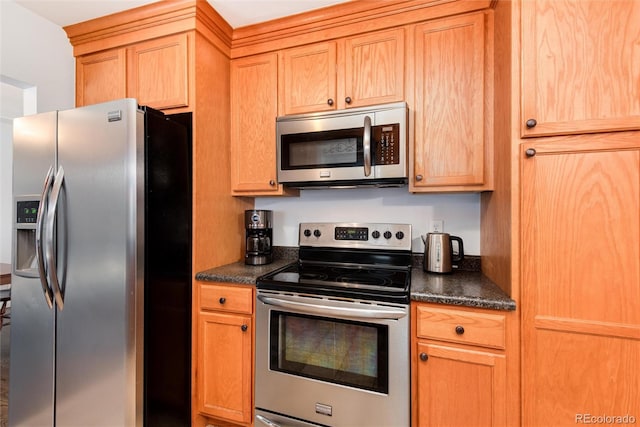 kitchen with dark countertops and appliances with stainless steel finishes