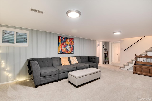 carpeted living room featuring stairs and visible vents