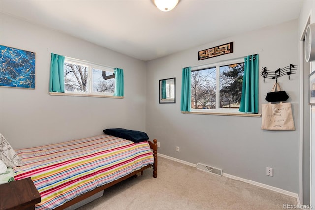 bedroom featuring visible vents, carpet floors, and baseboards