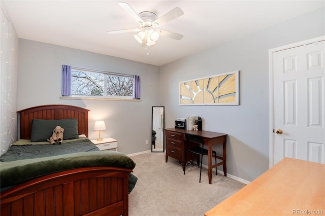 bedroom featuring baseboards, light colored carpet, and ceiling fan