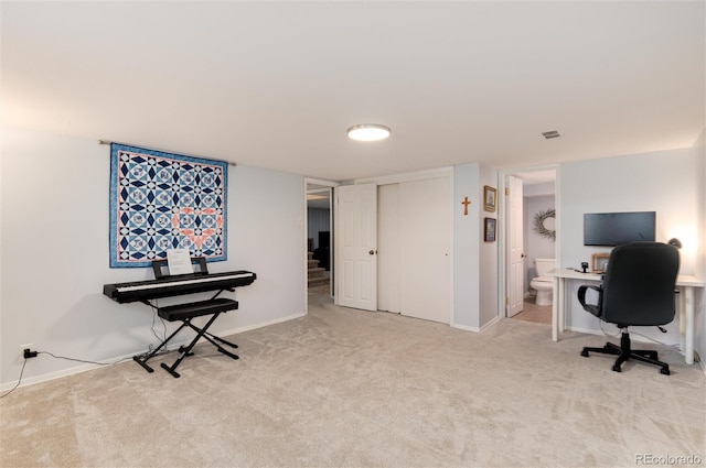 carpeted office with visible vents and baseboards