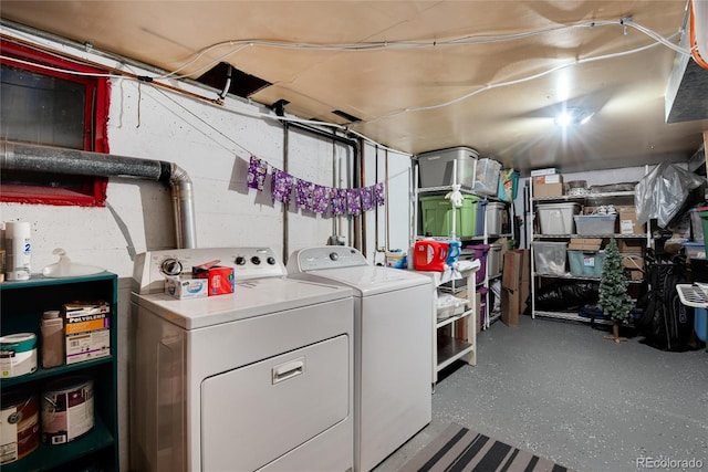 laundry area featuring laundry area, independent washer and dryer, and concrete block wall