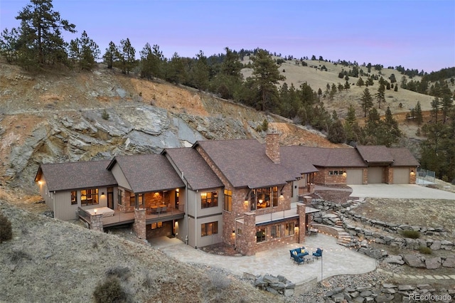 view of back house at dusk