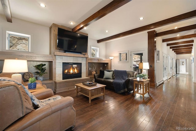 living room with dark hardwood / wood-style flooring, a fireplace, beamed ceiling, and baseboard heating