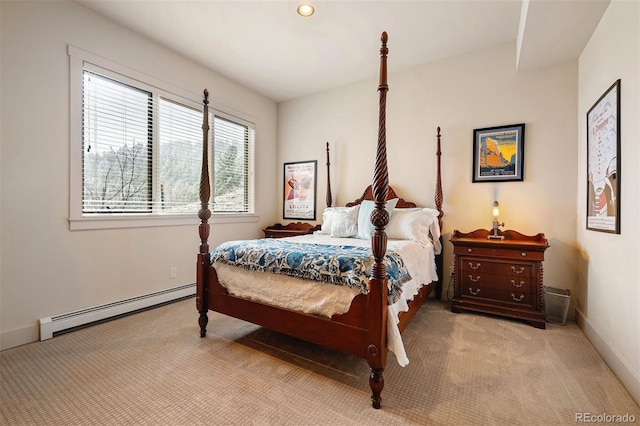 bedroom with light colored carpet and a baseboard heating unit