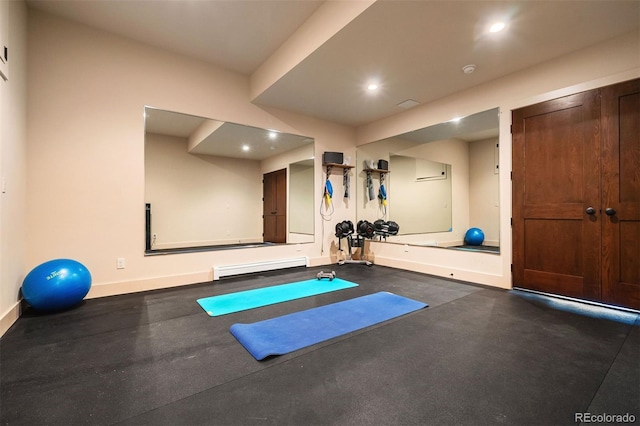 exercise area featuring baseboard heating