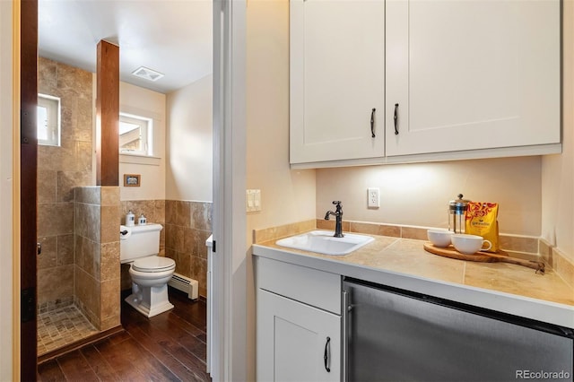 interior space featuring sink, baseboard heating, white cabinetry, tile walls, and dark hardwood / wood-style flooring