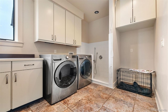 21609 Clarence Ln, Golden, CO 80401 - laundry room with washer and dryer, cabinet space, baseboards, and light stone finish floors