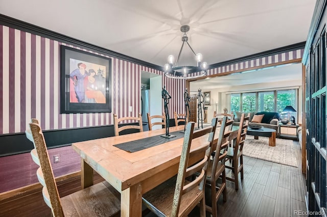 4878 W 98th Ave, Westminster, CO 80031 - dining space with wallpapered walls, a chandelier, dark wood-style flooring, and ornamental molding