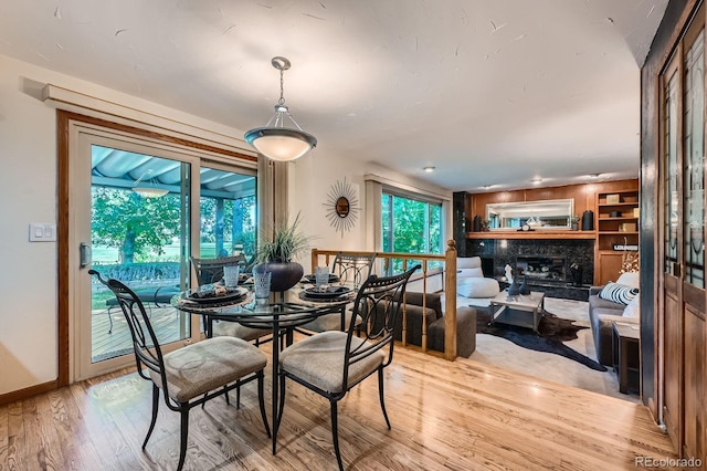 4878 W 98th Ave, Westminster, CO 80031 - dining space with light wood-type flooring and a premium fireplace